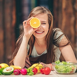woman eating healthy food to prevent dental emergencies in Summerfield