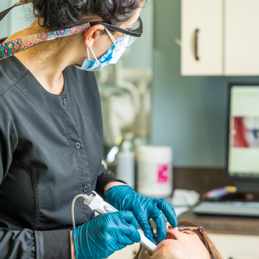 Smiling woman receiving dental treatment