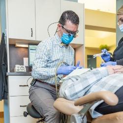 Dentist examining woman's smile