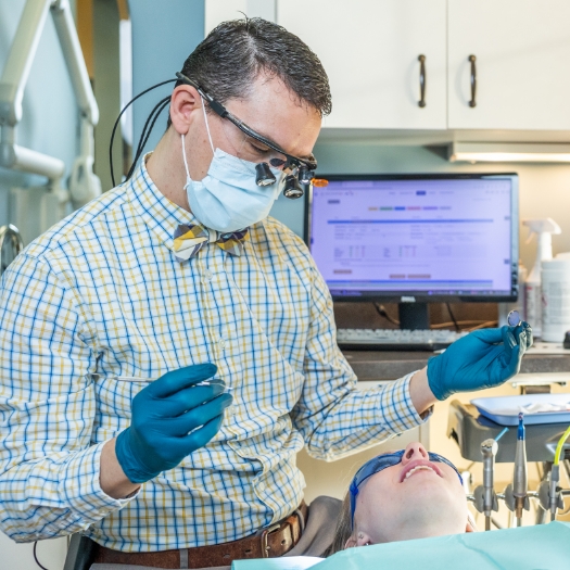 Doctor Parry using advanced technology to treat dental patient