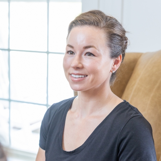 Woman in dental office smiling at dentist