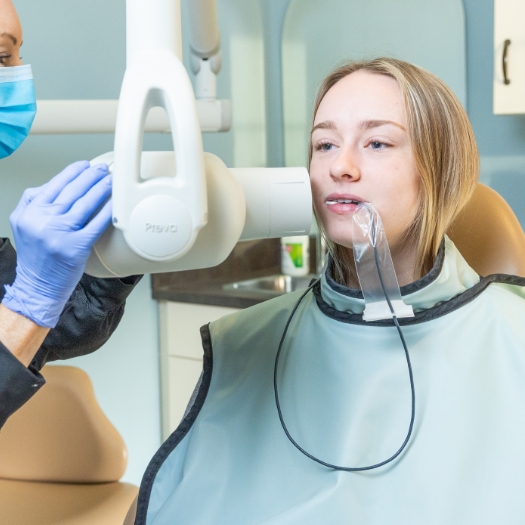 Woman in need of emergency dentistry holding jaw