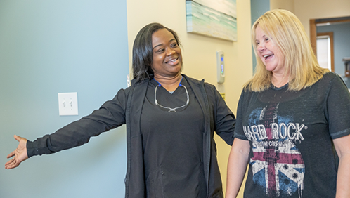 Dental team member guiding a patient in the office
