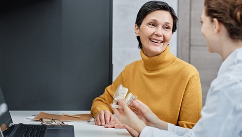 A woman discussing All-on-4 with her dentist