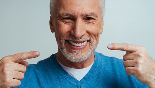 A man smiling after getting all-on-4 dental implants