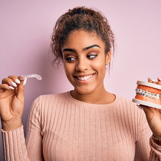 a patient comparing braces to clear aligners