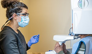 Dental team member taking scans of a patient's teeth