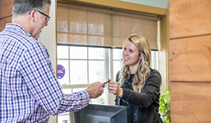 Man paying for his dental treatment