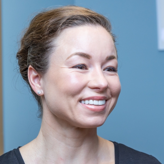 Woman looking in mirror at her smile