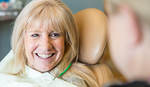Older woman smiling at her dentist