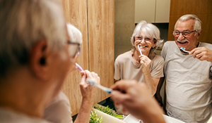 Man and woman brushing their teeth