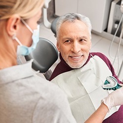 a patient smiling while undergoing the denture process