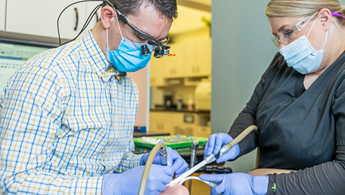 Dentist and assistant treating a patient