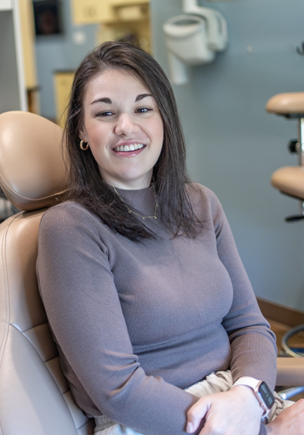 Woman in the dental chair smiling after gum disease treatment in Summerfield