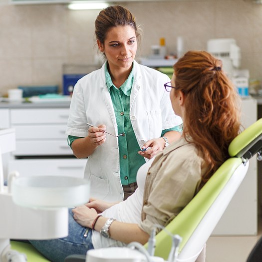 Dentist explaining cost of dental implants in Summerfield