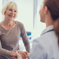 Implant dentist in Summerfield shaking hands with a patient