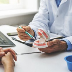 dentist explaining dental implants during consultation 