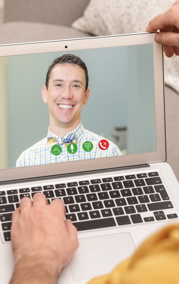 Dentist talking to patient via online video chat platform
