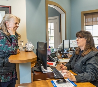 Smiling woman talking to dentist