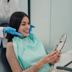 Woman smiling at reflection in mirror