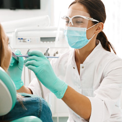 Dentist examining patient's teeth