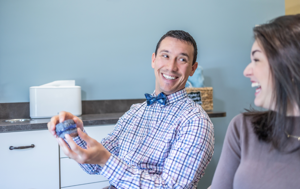 Summerfield dentist Doctor Tristan J Parry showing a model of the teeth to a patient