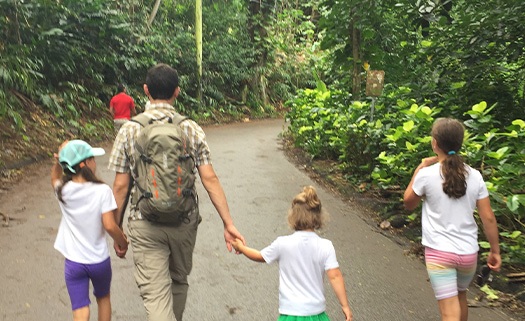 Doctor Parry and his family walking on a forest trail