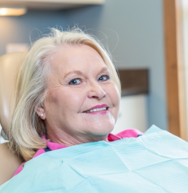 man smiling while visiting dentist 