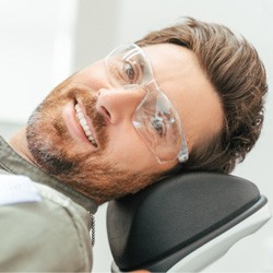 Patient smiling while sitting in treatment chair