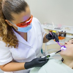 A dentist treating a sedated patient
