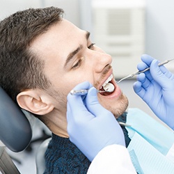 patient visiting dentist to prevent dental emergencies in Summerfield
