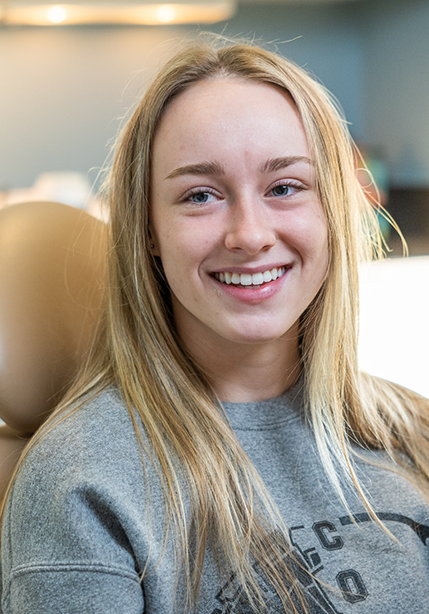 Young blonde woman smiling in the dental chair