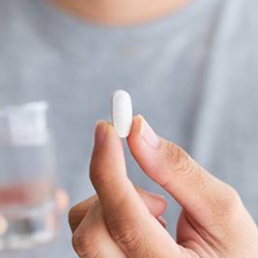 Man holding an oral conscious sedation dentistry pill