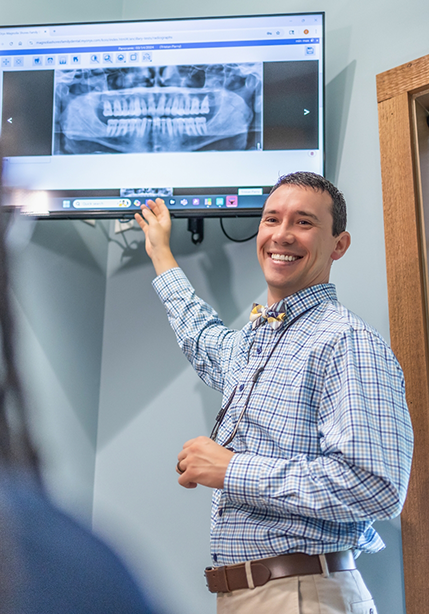 Doctor Parry showing a patient an x ray of their teeth