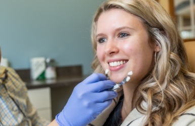 Man in need of restorative dentistry holding jaw