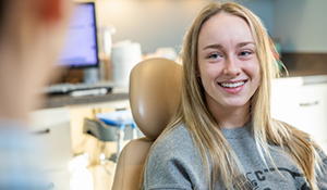 Young woman smiling at her dentist