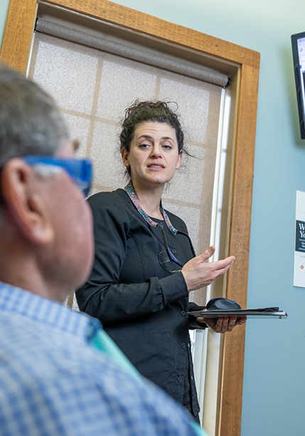 Dental team member talking to a patient about veneers in Summerfield