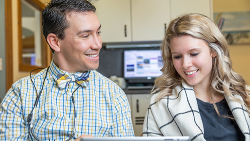 Doctor Parry showing a screen to a patient
