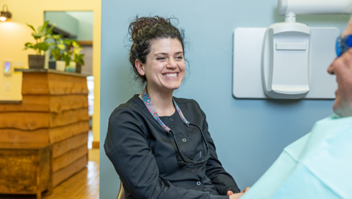 Dental team member smiling at a patient
