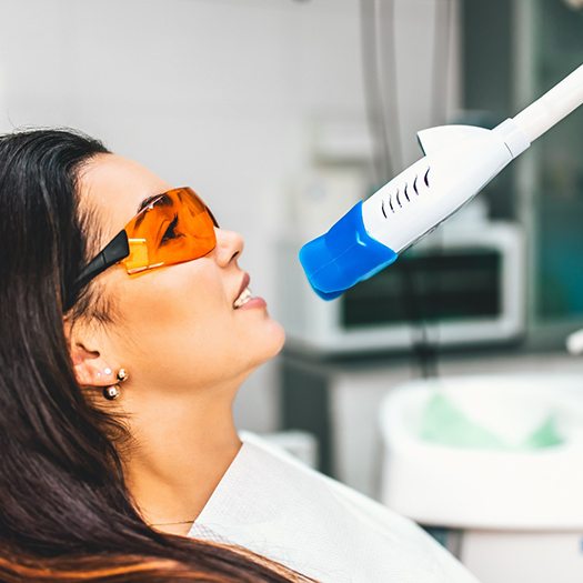 A woman receiving teeth whitening in Summerfield