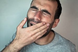 man suffering toothache