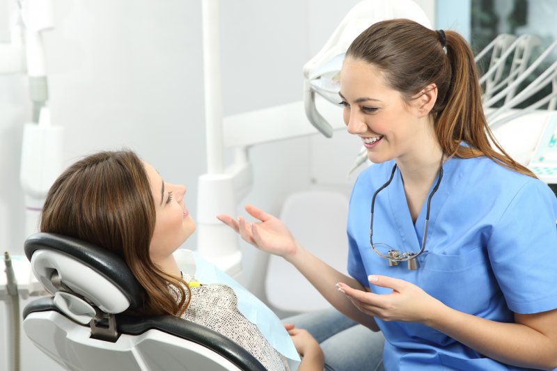 patient speaking to dentist at dental implant consultation