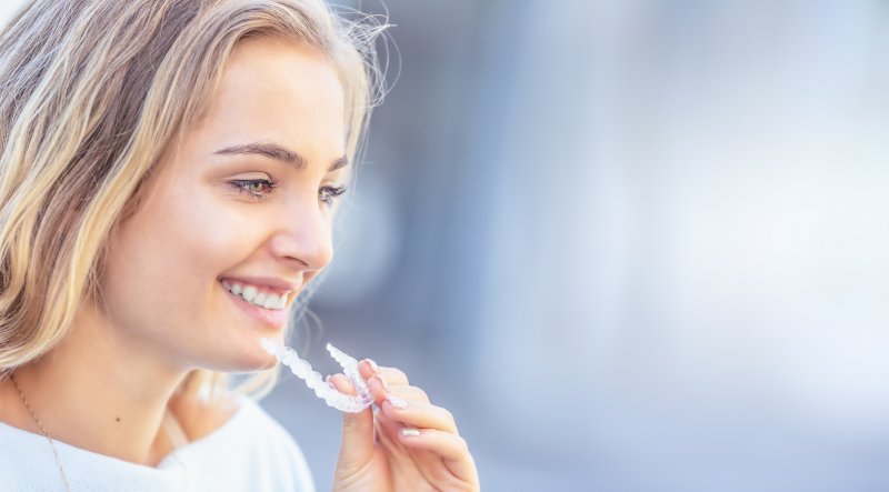 A woman doing Invisalign during cold and flu season