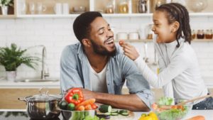 a father and daughter enjoying healthy foods for their teeth