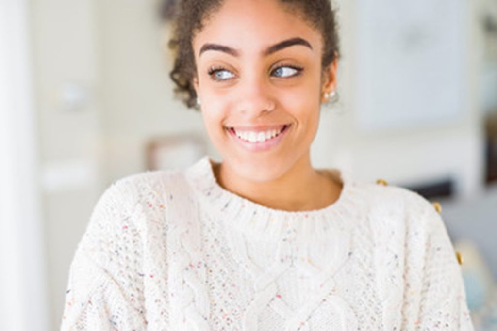 a patient smiling after receiving cosmetic dental work