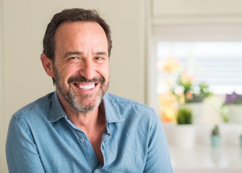 An older man smiling with his dentures