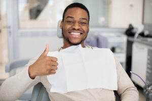 Man smiling and giving a thumbs up